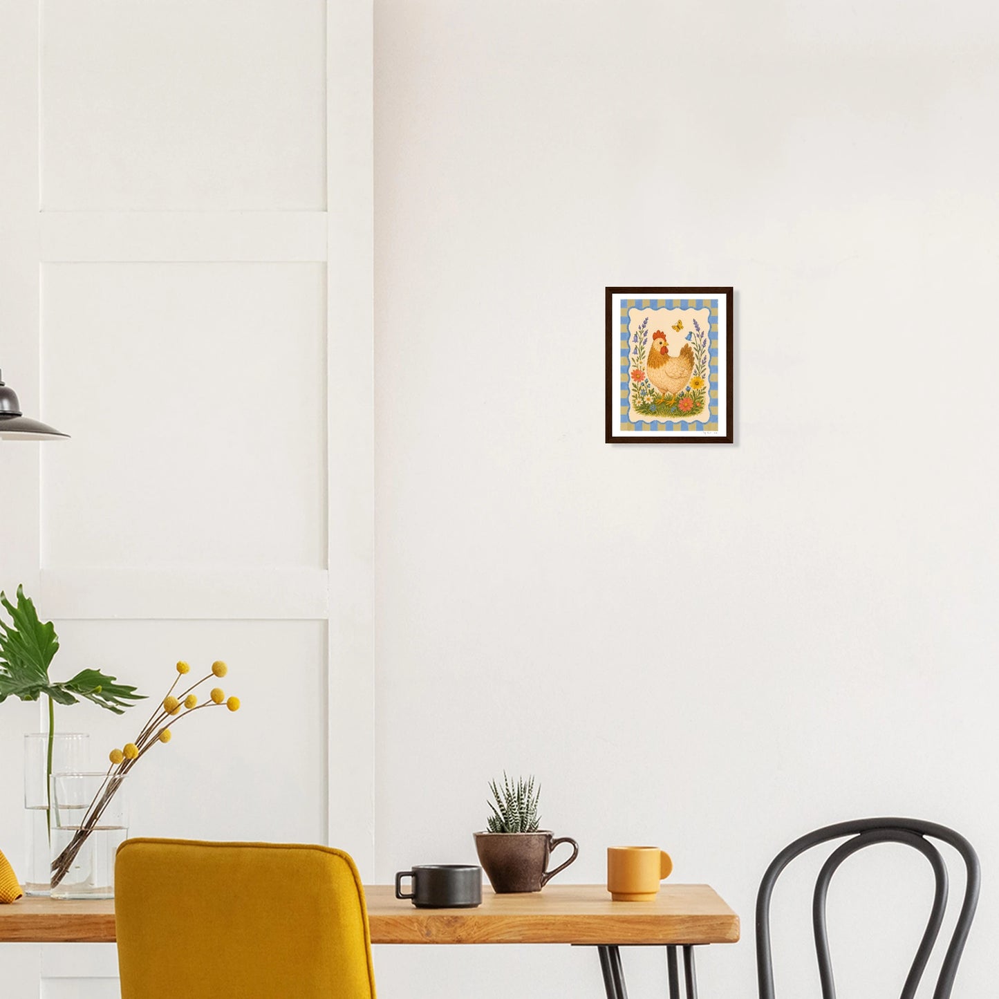 Modern interior with a wooden table, chairs, and wall art of a sunset over water.