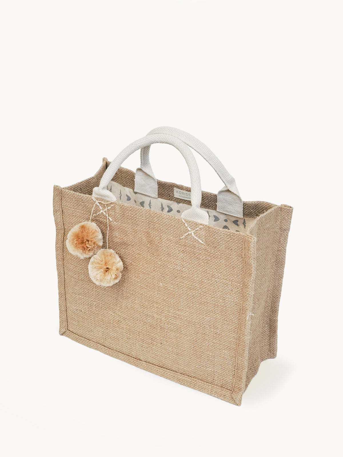 Small DC-KORISSA jute canvas gift bag with white pompom accents and cotton lining, ideal for eco-friendly gift wrapping.