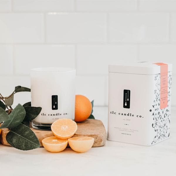 Orange citrus soy candle from DC-TLC Candle Co. featuring a decorative orange citrus tree design on the label.