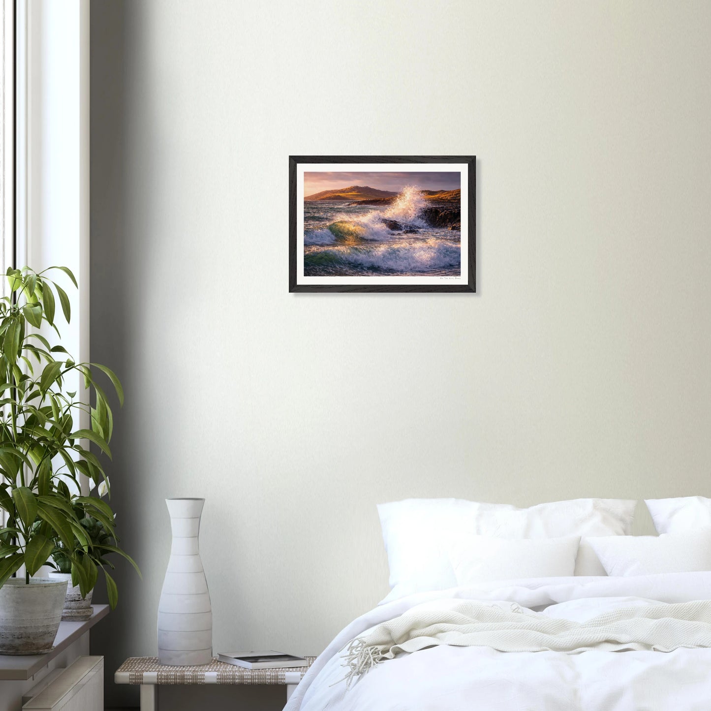 Framed artwork of a wave crashing on a beach in a bedroom setting.