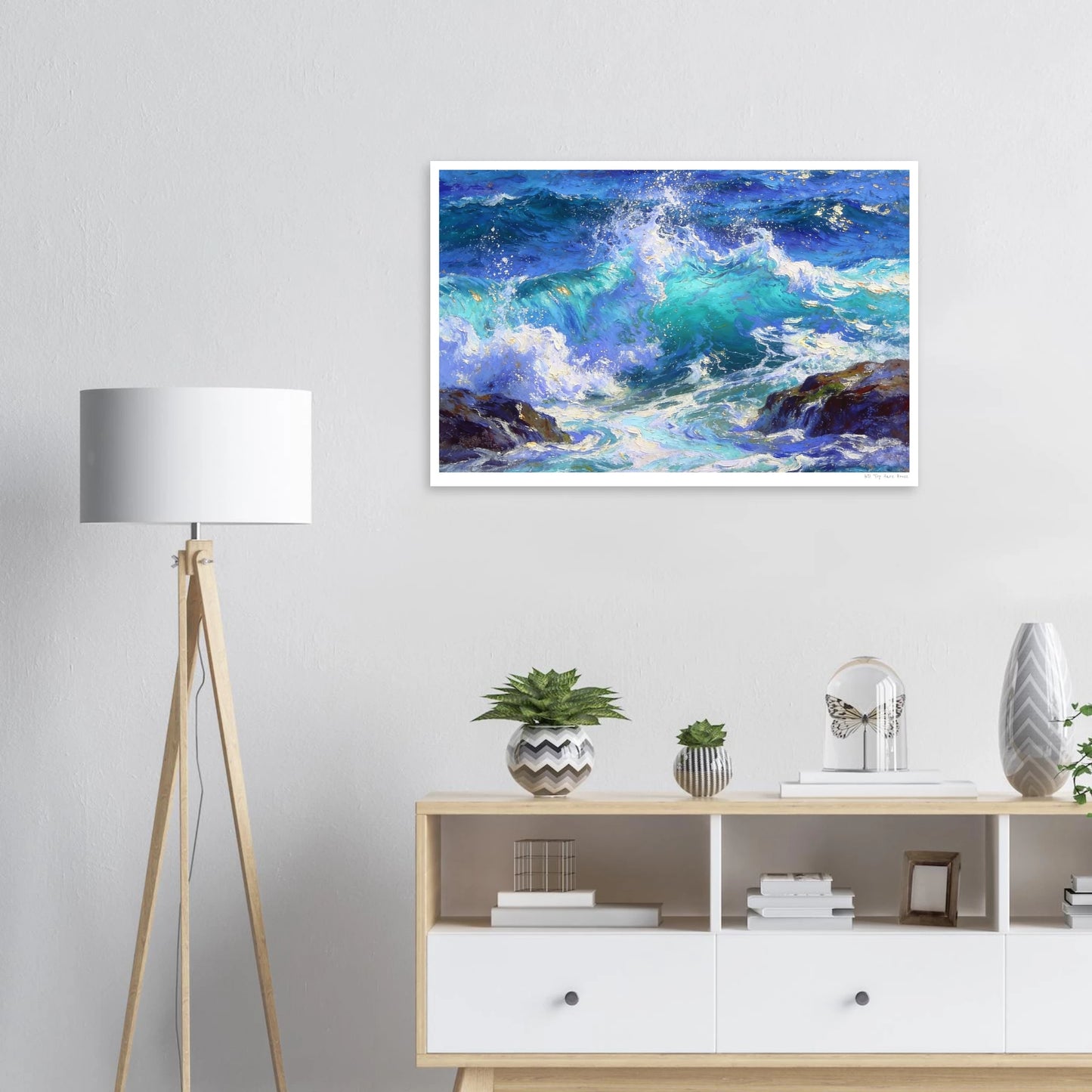 Framed artwork of a wave painting on a wall above a wooden shelf with decorative items.