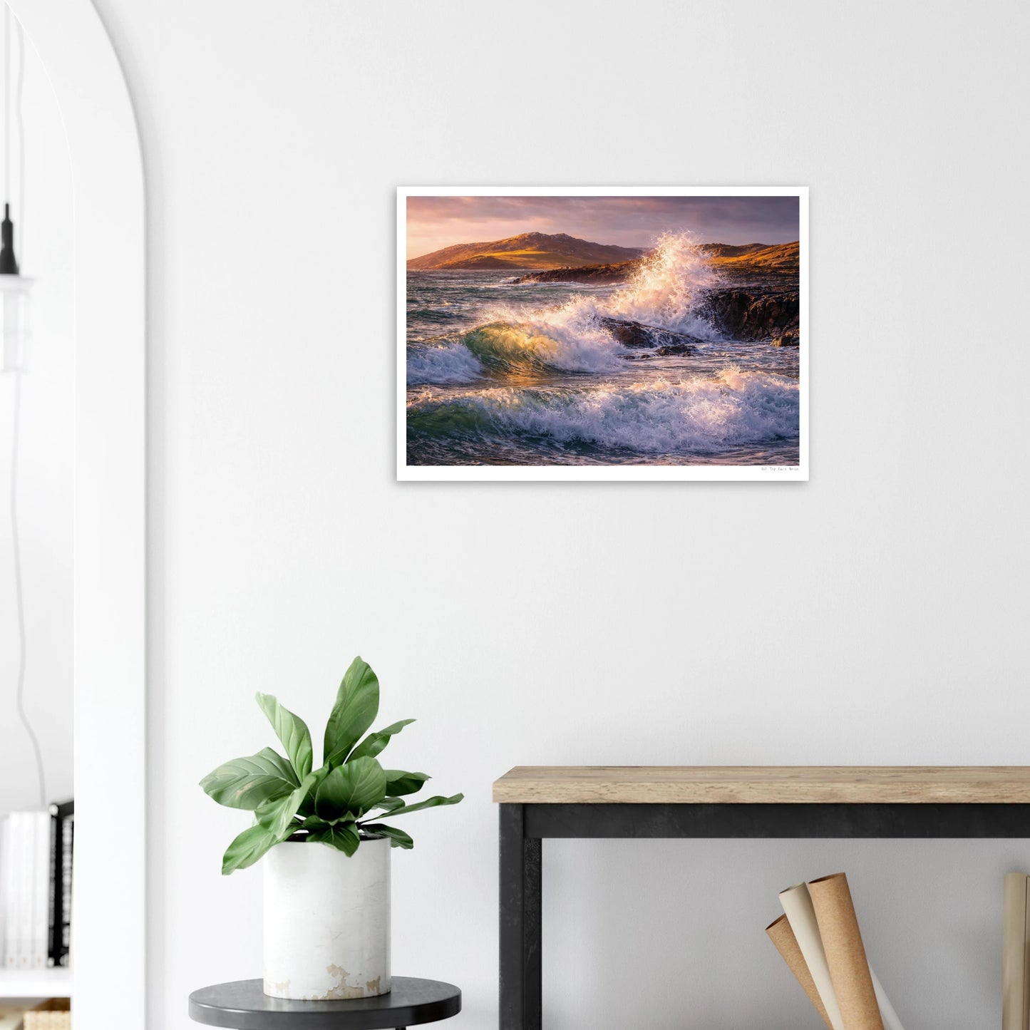 Framed artwork of a wave crashing on a beach in a modern interior setting.