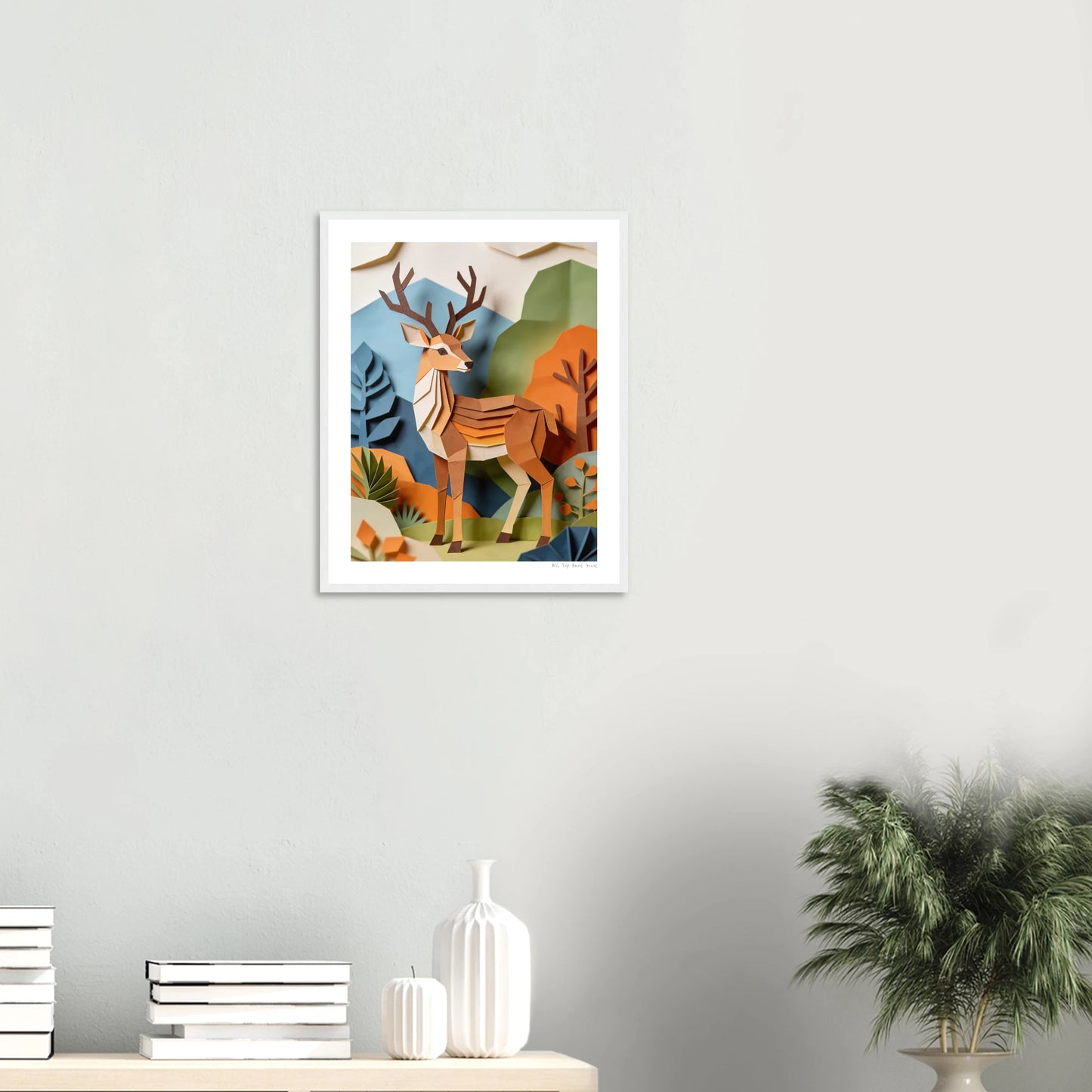 Framed artwork of a deer in a natural setting on a wall above a shelf with decorative items.