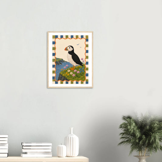 Framed artwork of a puffin on a striped background in a room with decor elements.