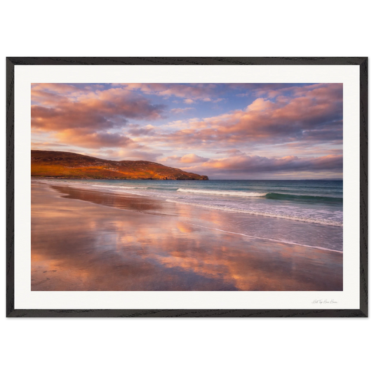 Framed artwork of a beach scene with a sunset sky.