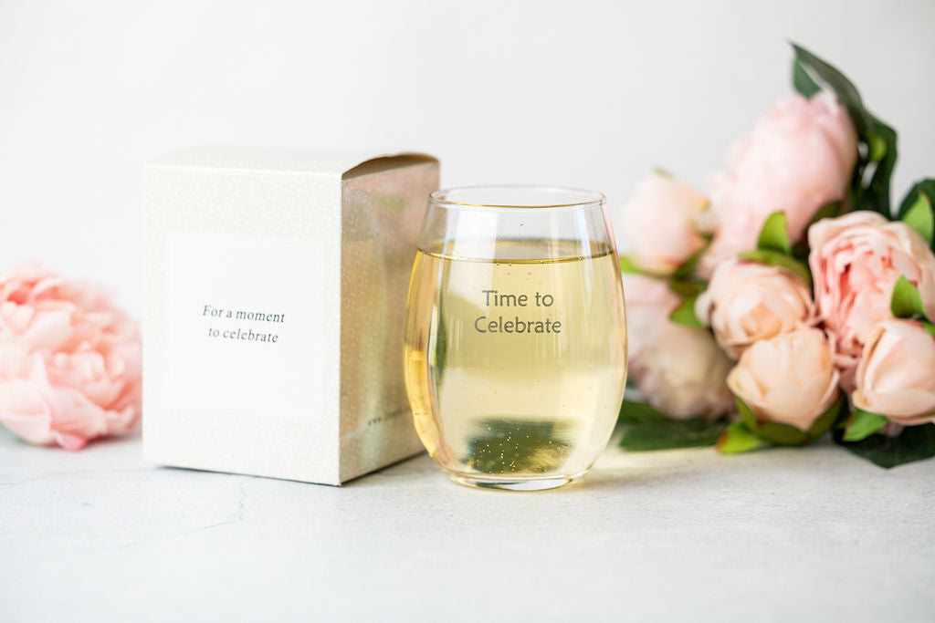 Celebration gift box with a glass cup labeled "Time to Celebrate" from DC-Lizush, decorated with festive ribbons and confetti.