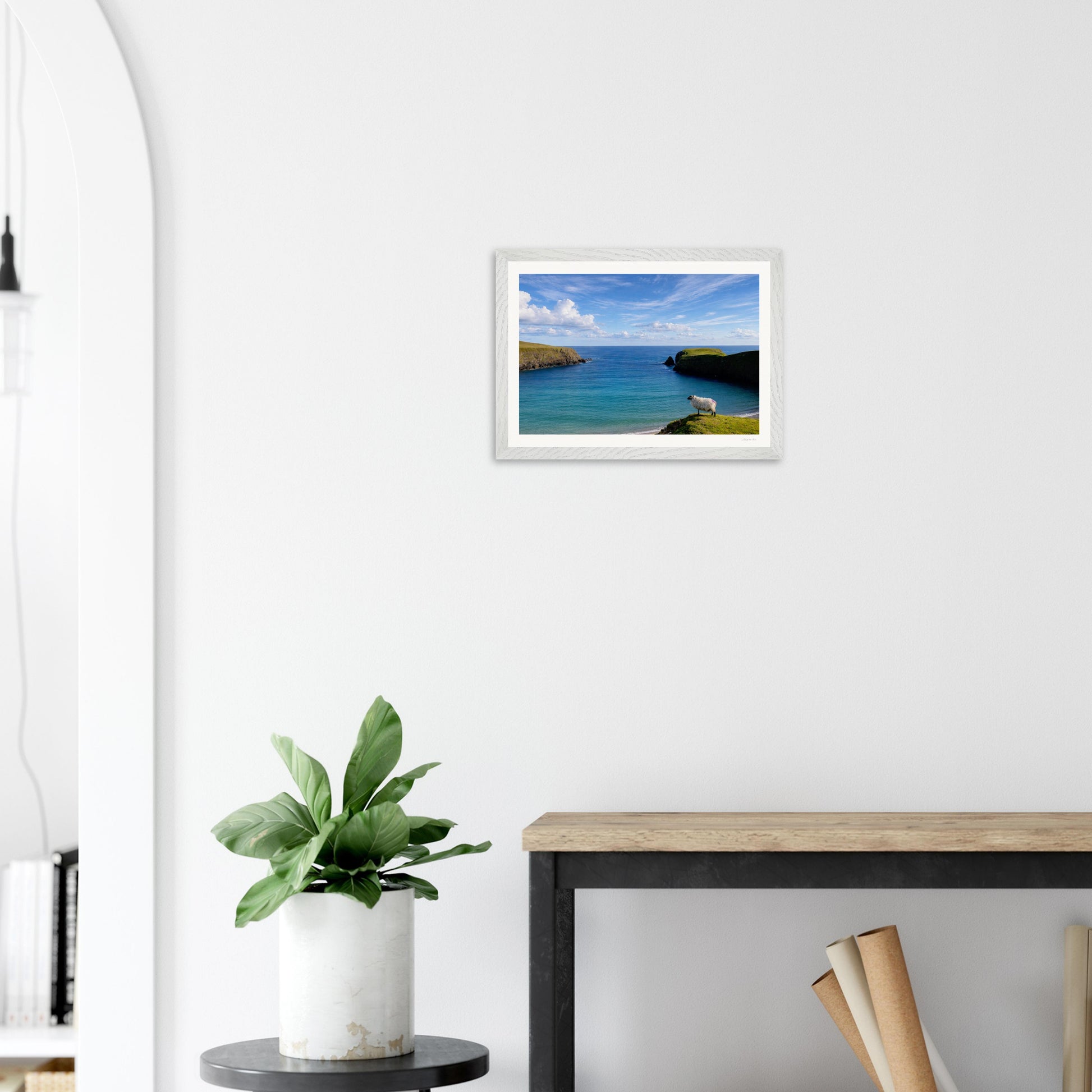 Framed Irish landscape print "Next Stop New York" by Hill Top Hare House, modern white frame, displayed in a lobby setting