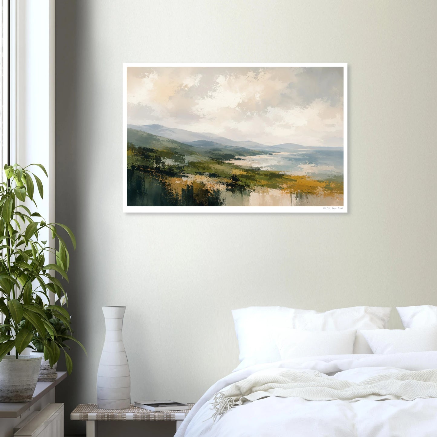 Framed landscape painting on a wall above a bed in a bedroom.