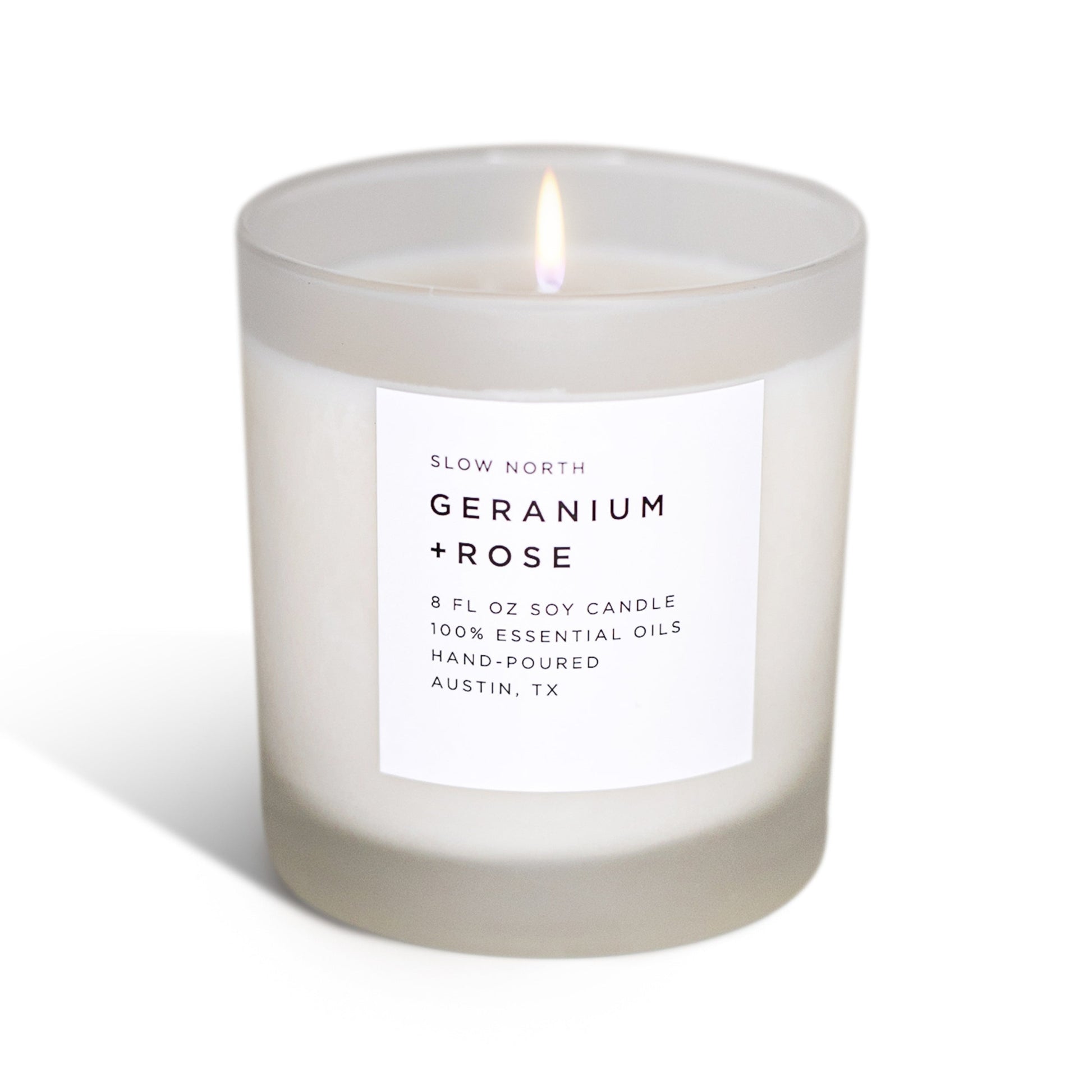 Geranium and rose scented signature candle by DC-Slow North in a glass jar, showcasing the non-toxic candle design.
