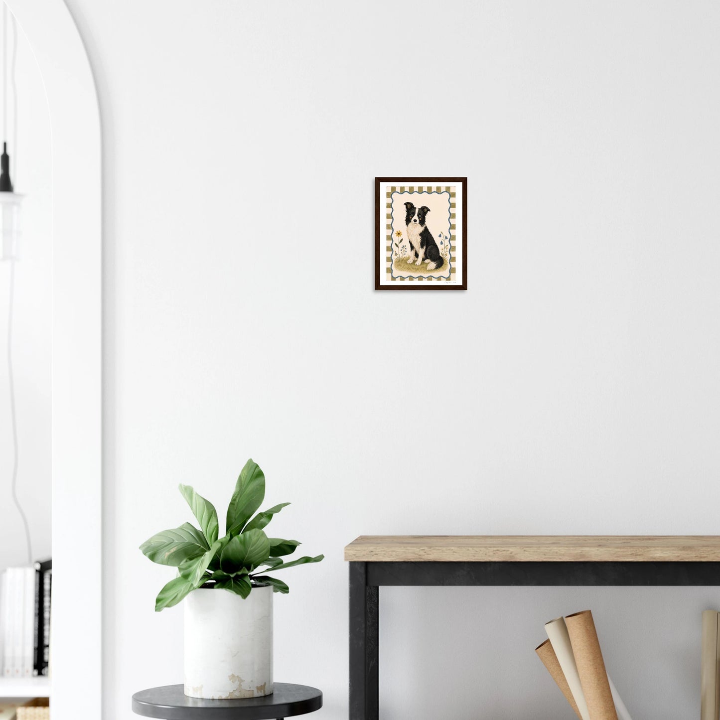 Modern interior with a plant, table, and wall art on a white wall.