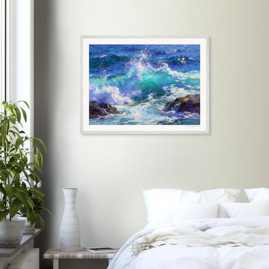 Framed painting of ocean waves on a wall above a bed