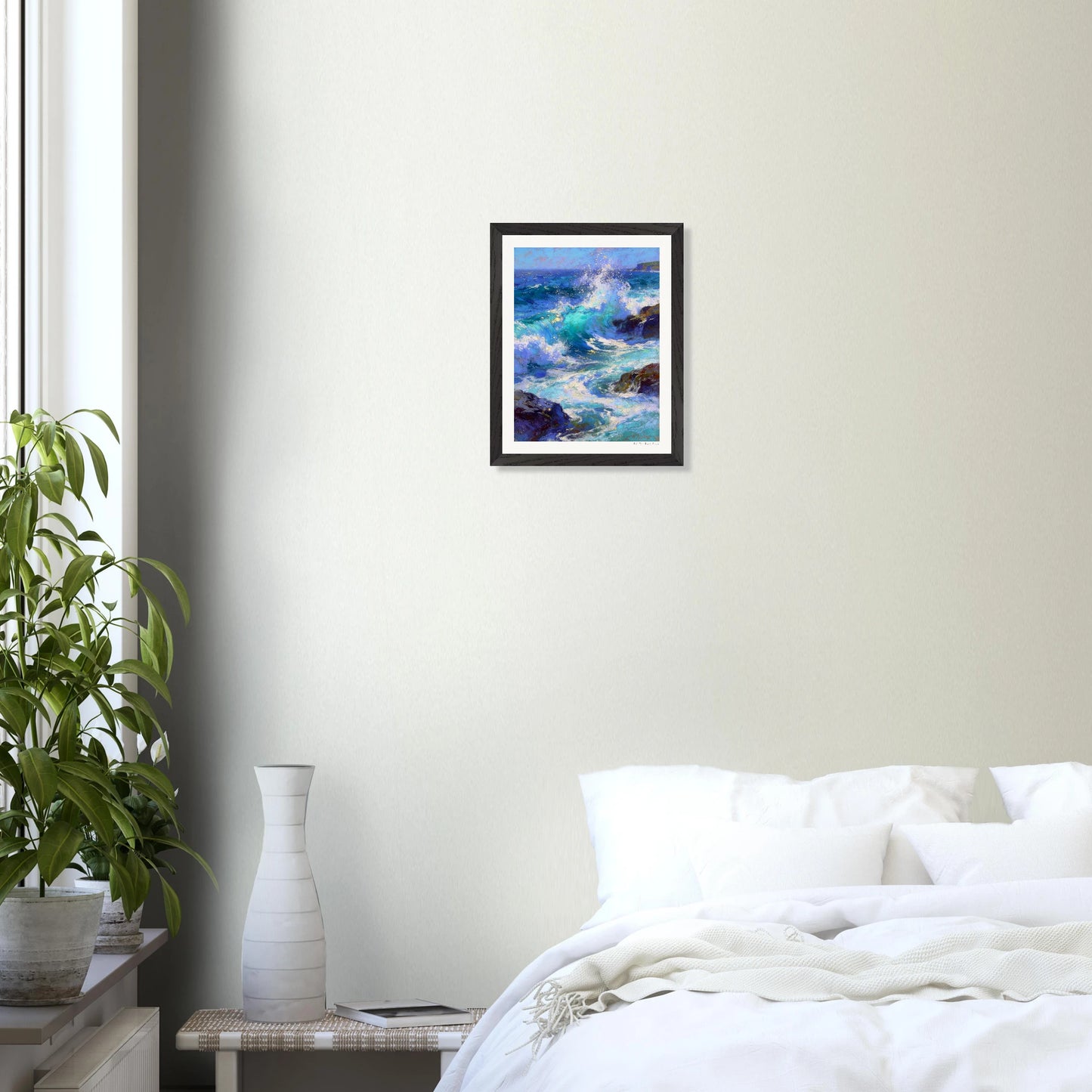 Framed artwork of a seascape above a bed in a bedroom