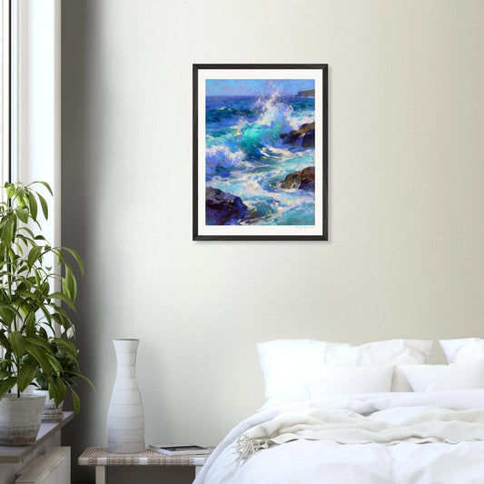 Framed painting of ocean waves on a wall above a bed