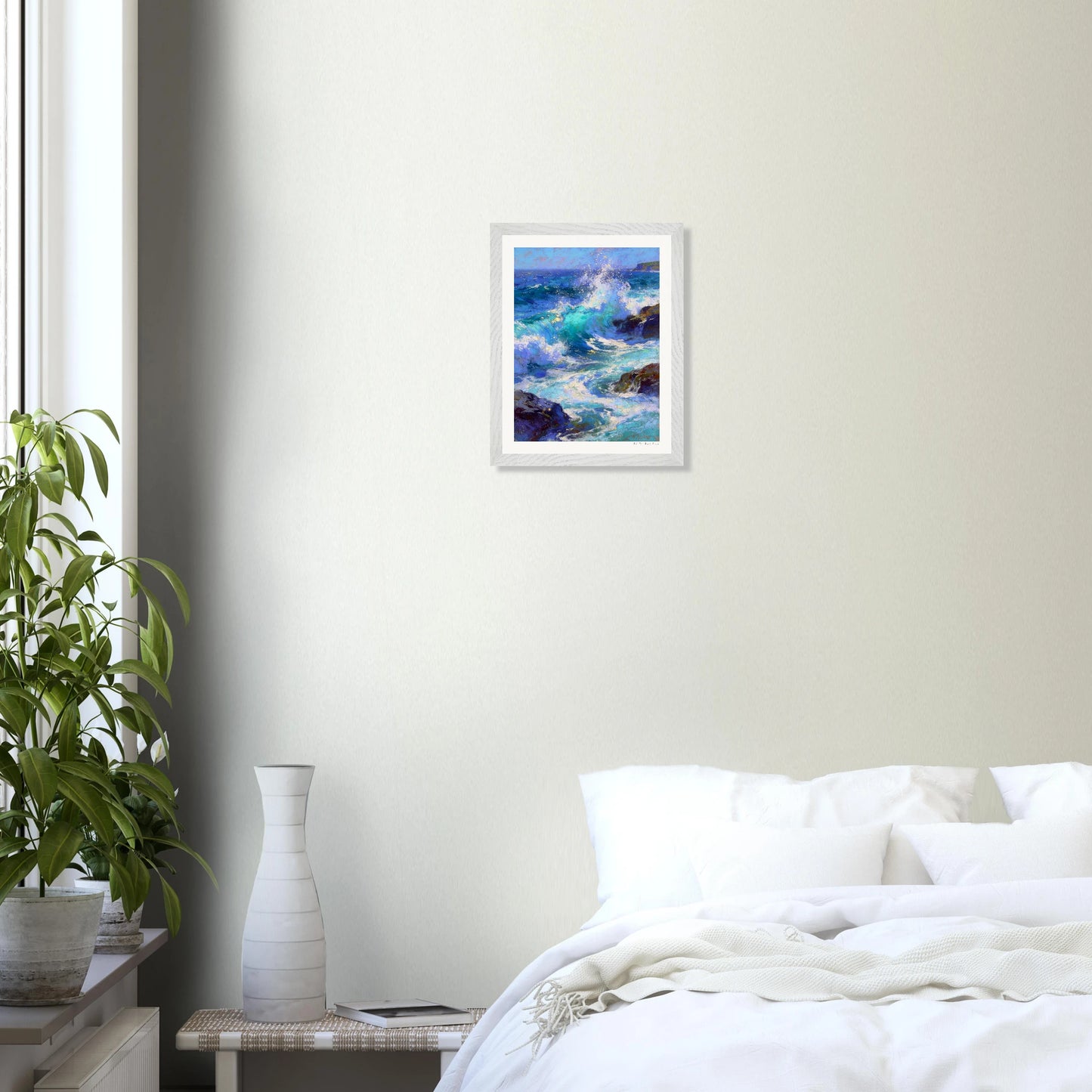 Framed artwork of a seascape on a wall above a bed in a bedroom.