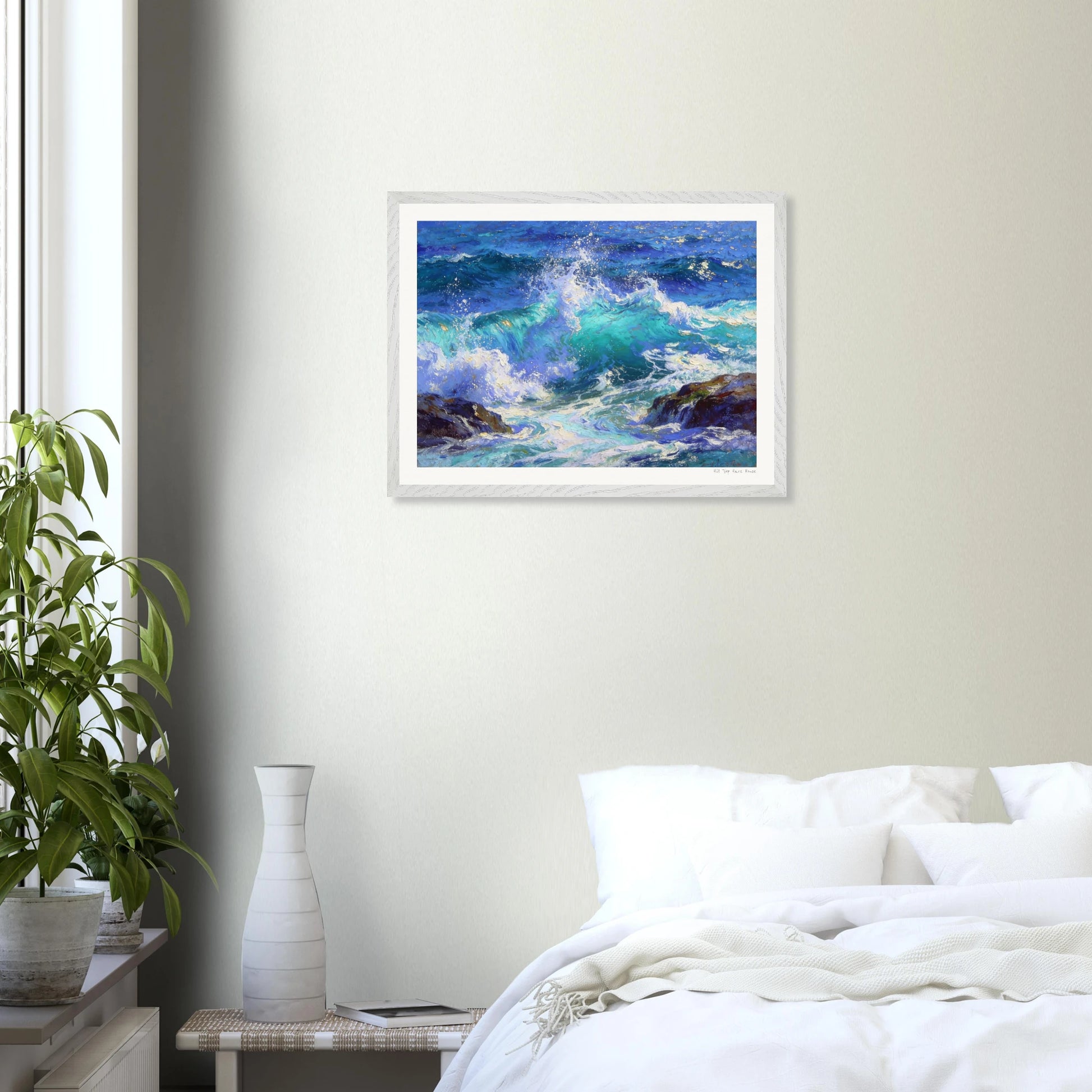 Framed artwork of a seascape above a bed in a bedroom